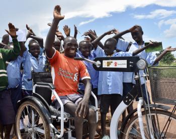 Moses Oriam with peers after receiving his tricycle through education can not wait project from light for the world and save the children in Eastern Equatoria 