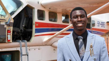 Daniel Peni poses for a picture after landing at Kajjansi Airstrip, Uganda