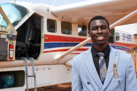 Daniel Peni poses for a picture after landing at Kajjansi Airstrip, Uganda