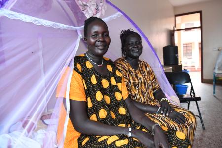 Elizabeth and Ayaar sitting on the bed at the Reconciliation Hospital