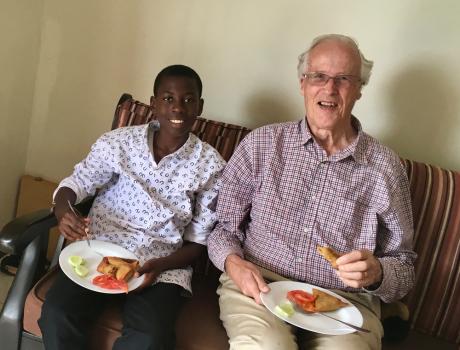 Rev. Canon Peter Marshall and teenage Daniel sharing a meal together
