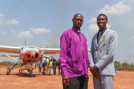 Archbishop Samuel Peni and his son Daniel Peni pose for a picture together at Kajjansi Airstrip in Uganda