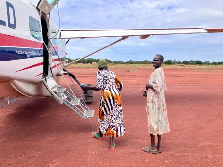 Nyanut boards the plane at Tonj Airtsrip heading to Juba for her life-saving surgery